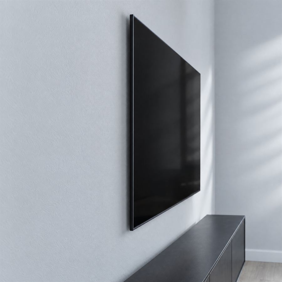 Una tele de pantalla plana montada al ras en una pared gris claro, sin cables a la vista.